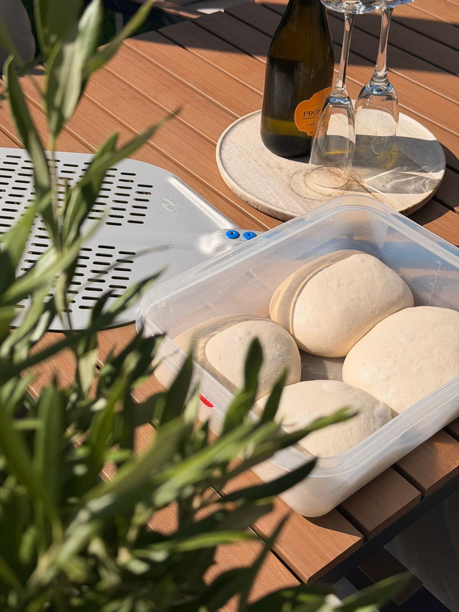 Proofed dough balls in a container
